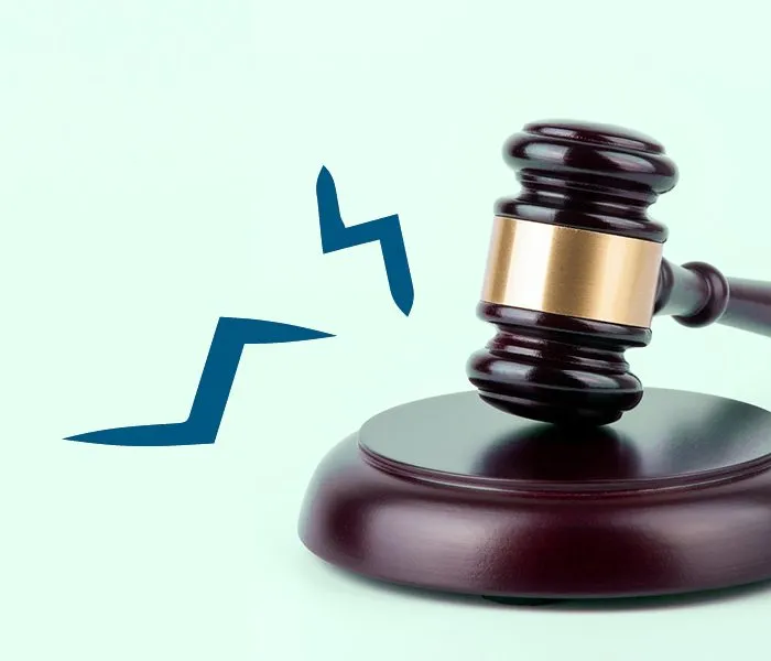 A judge's gavel striking a sounding block, with motion lines indicating impact on a light grey background.