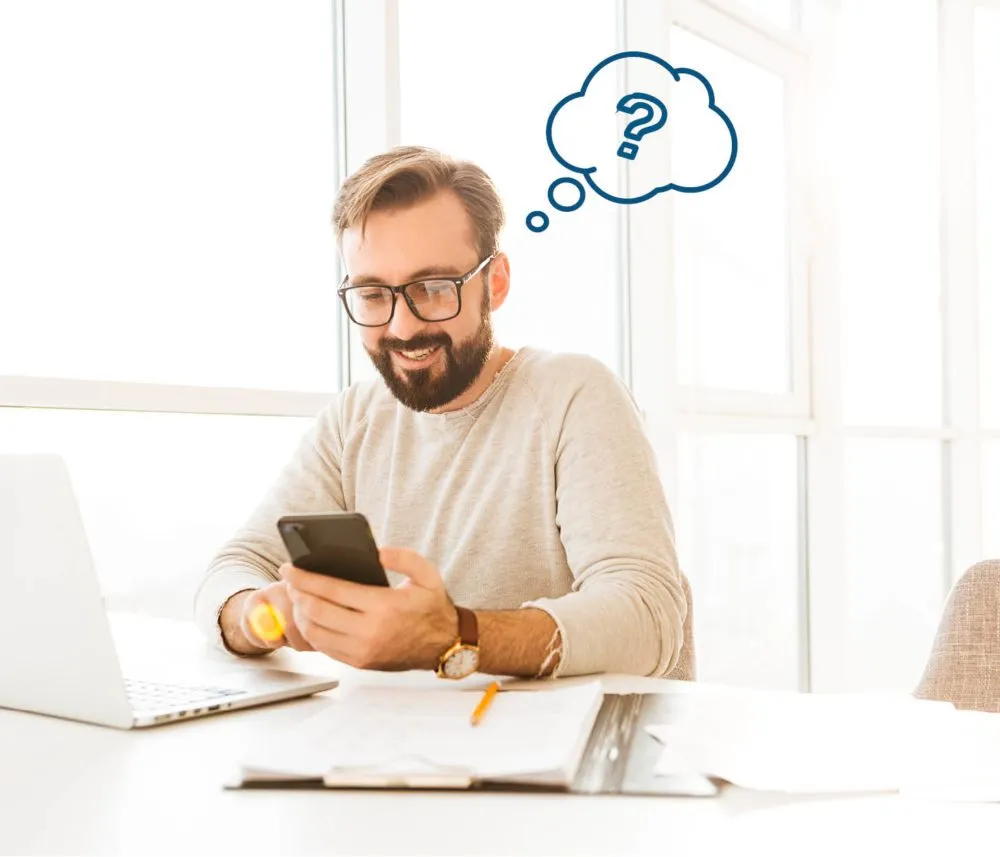 Man on his phone with question mark above his head.