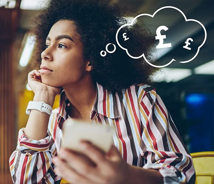 A person in a striped shirt holds a phone and looks away thoughtfully, with a thought bubble depicting pound symbols (£).