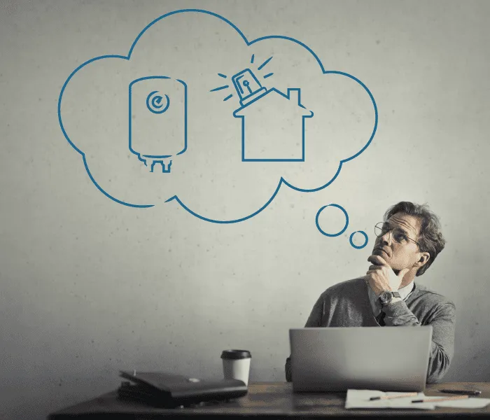 A person sitting at a desk with a laptop and coffee cup, contemplating sketches of a water heater and a house inside a thought bubble.