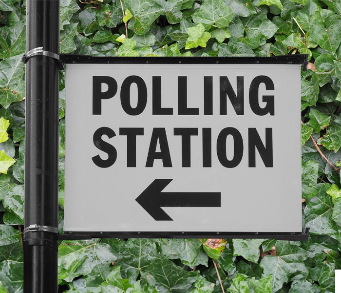 Polling Station sign on ivy wall